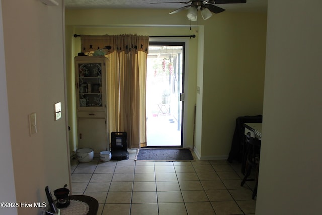 entryway with light tile patterned floors and ceiling fan