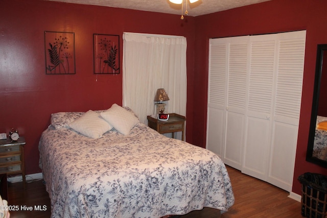 bedroom with wood finished floors and a closet