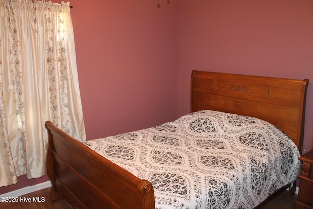 bedroom with wood finished floors