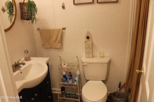 full bathroom with toilet, tile walls, a shower with shower curtain, and vanity