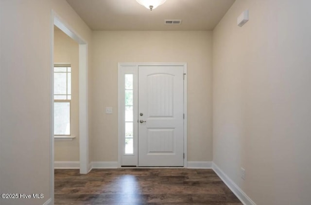 entryway featuring visible vents, baseboards, and wood finished floors