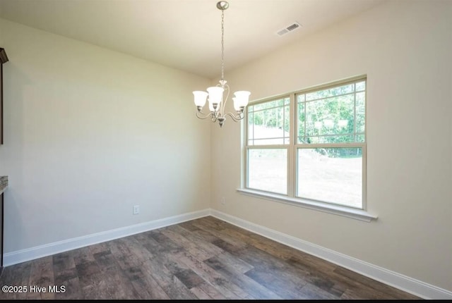 unfurnished dining area featuring a notable chandelier, visible vents, baseboards, and dark wood finished floors