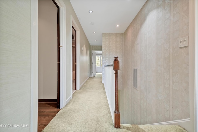 hallway with recessed lighting, light wood-type flooring, visible vents, light carpet, and baseboards