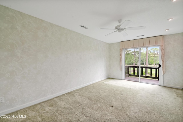 spare room featuring visible vents, a ceiling fan, carpet flooring, and baseboards