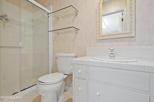 bathroom featuring toilet, a stall shower, wallpapered walls, and tile patterned floors