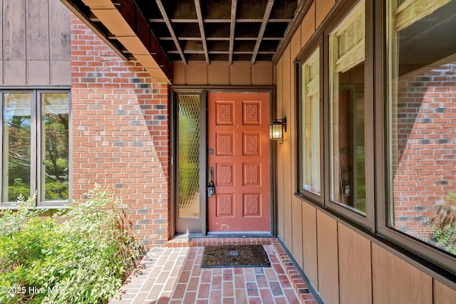 entrance to property featuring brick siding