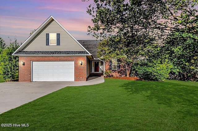 traditional-style home with concrete driveway, brick siding, a garage, and a front lawn