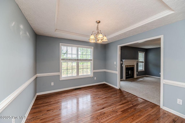 interior space with a textured ceiling, visible vents, a chandelier, dark wood-style flooring, and baseboards