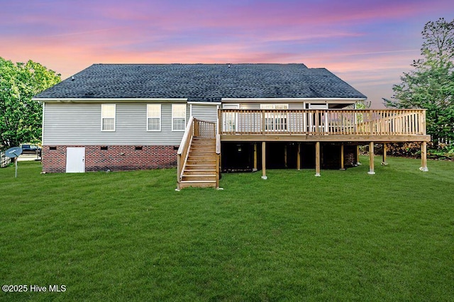 back of house with crawl space, stairway, a lawn, roof with shingles, and a deck