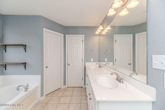 bathroom featuring a bath, tile patterned floors, double vanity, and a sink