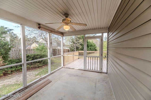 unfurnished sunroom with ceiling fan