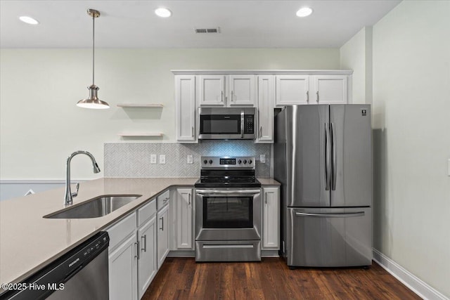 354 Trevally Ct, Southport, NC 28461 - kitchen featuring appliances with stainless steel finishes, a sink, open shelves, white cabinets, and dark wood-style flooring