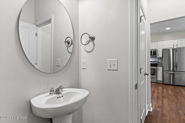 354 Trevally Ct, Southport, NC 28461 - bathroom with a sink, recessed lighting, and wood finished floors