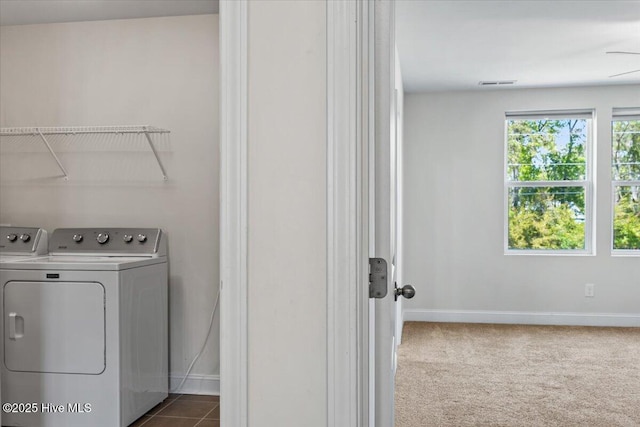 354 Trevally Ct, Southport, NC 28461 - laundry room featuring washing machine and clothes dryer, baseboards, and dark colored carpet