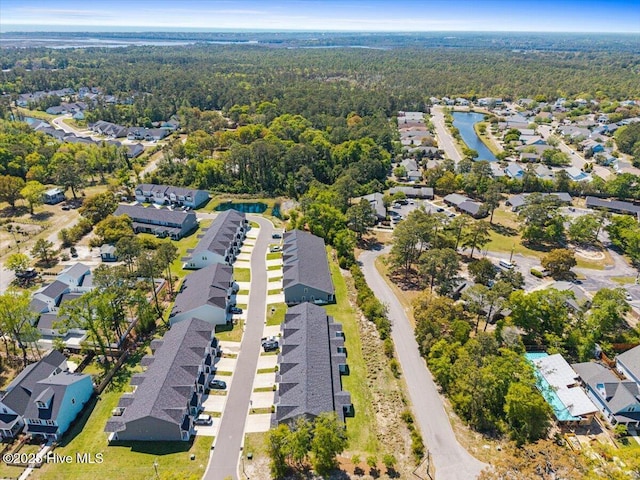 354 Trevally Ct, Southport, NC 28461 - aerial view of property and surrounding area with nearby suburban area, a heavily wooded area, and a nearby body of water