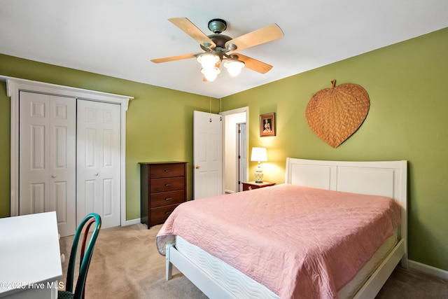carpeted bedroom with baseboards, ceiling fan, and a closet