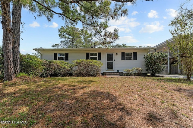 ranch-style home with fence, entry steps, and a front lawn