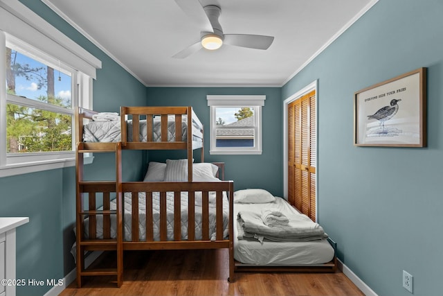 bedroom with ornamental molding, a closet, and multiple windows