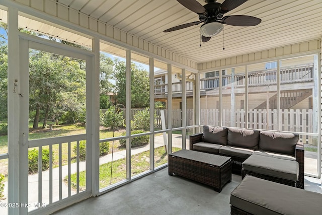sunroom with an outdoor living space, ceiling fan, and a wealth of natural light