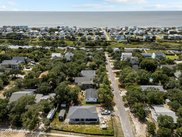 drone / aerial view with a water view and a residential view