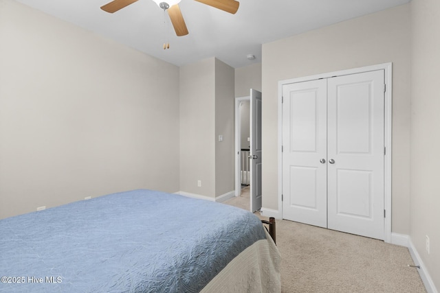 bedroom with carpet flooring, a closet, baseboards, and ceiling fan