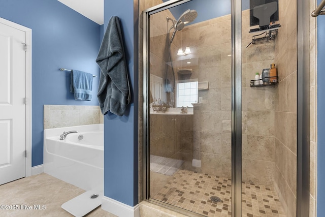 bathroom featuring a bath and a stall shower