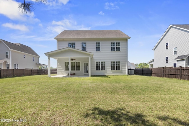 back of property featuring central AC, a yard, a fenced backyard, a ceiling fan, and a patio area