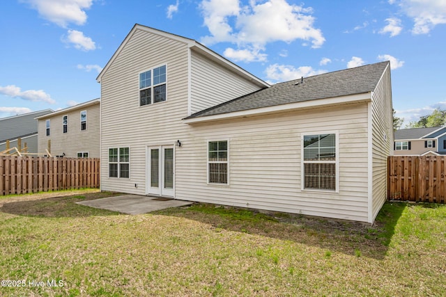 4541 Parsons Mill Dr, Castle Hayne, NC 28429 - rear view of house with a fenced backyard, a patio, a lawn, and roof with shingles