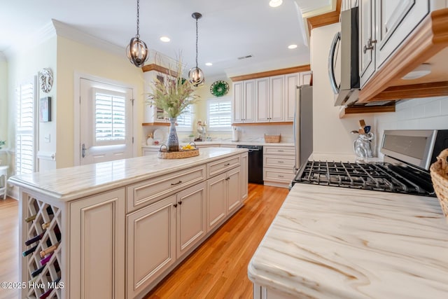kitchen with recessed lighting, a center island, decorative light fixtures, appliances with stainless steel finishes, and light wood finished floors
