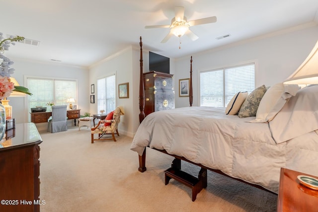 bedroom with ceiling fan, ornamental molding, visible vents, and carpet floors