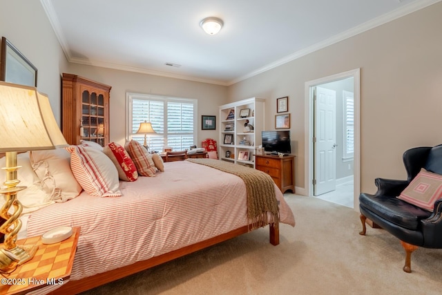 bedroom featuring visible vents, light colored carpet, ornamental molding, and ensuite bathroom