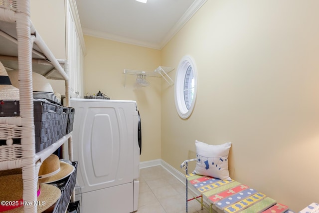 clothes washing area with washer / clothes dryer, baseboards, light tile patterned floors, laundry area, and crown molding