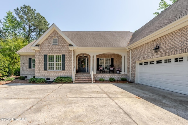 ranch-style house with a porch, crawl space, brick siding, driveway, and roof with shingles