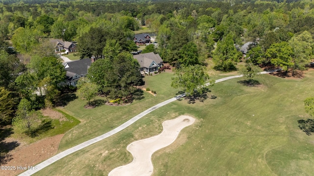 bird's eye view with golf course view and a forest view