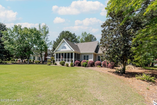 view of front of home with a front lawn and a sunroom