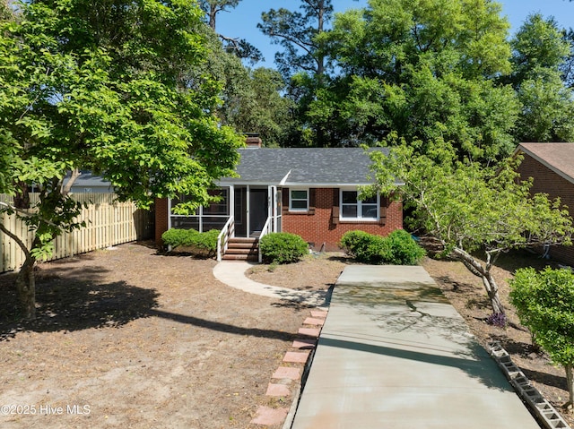 907 Bonham Ave, Wilmington, NC 28403 - view of front of house featuring fence, brick siding, and roof with shingles