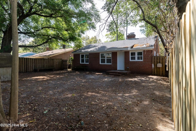907 Bonham Ave, Wilmington, NC 28403 - back of property featuring brick siding, a chimney, and fence