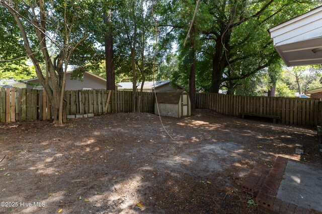 907 Bonham Ave, Wilmington, NC 28403 - view of yard with an outdoor structure, a shed, and a fenced backyard