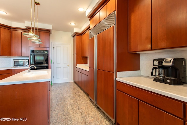 kitchen featuring light countertops, tasteful backsplash, and a sink