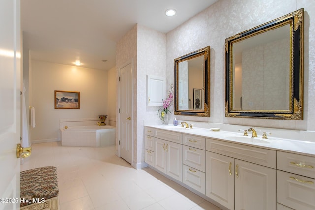 bathroom featuring double vanity, a garden tub, baseboards, and a sink