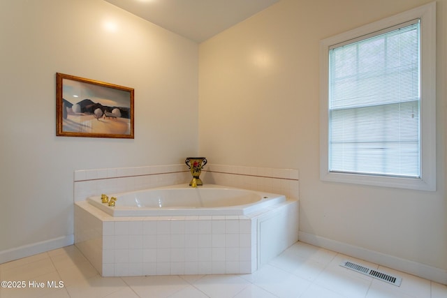bathroom featuring visible vents, baseboards, tile patterned flooring, and a garden tub