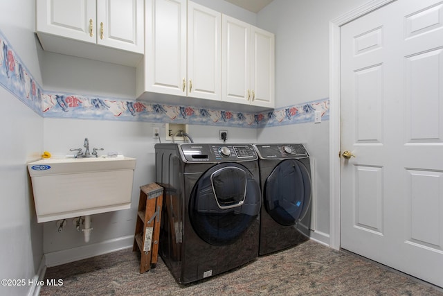 clothes washing area with baseboards, separate washer and dryer, a sink, and cabinet space