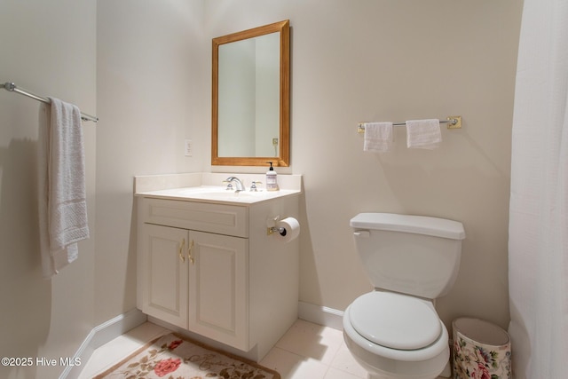 bathroom featuring tile patterned flooring, toilet, vanity, and baseboards