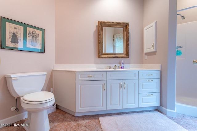 bathroom featuring toilet, walk in shower, vanity, and baseboards