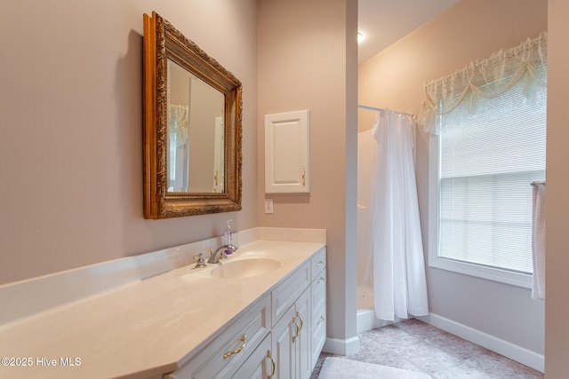 bathroom featuring baseboards and vanity