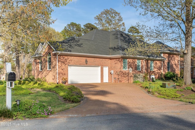 view of front of home featuring brick siding, a garage, and driveway