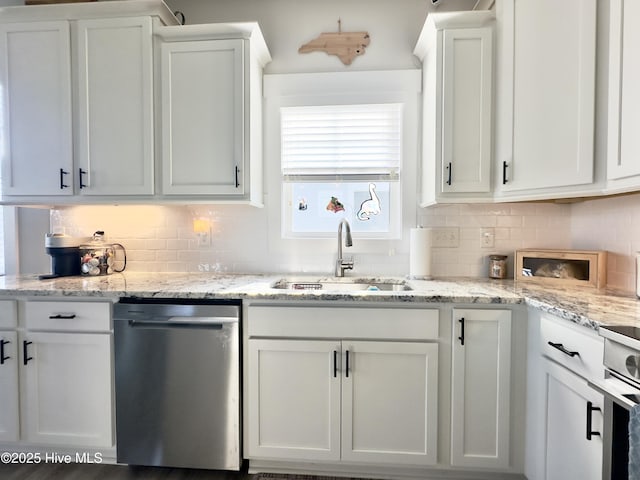kitchen featuring dishwasher, stove, a sink, backsplash, and white cabinets