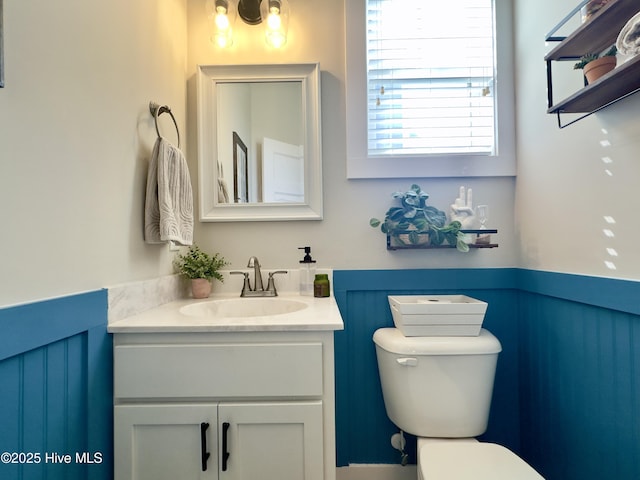 bathroom featuring vanity and toilet