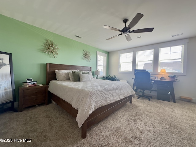 carpeted bedroom featuring ceiling fan and visible vents