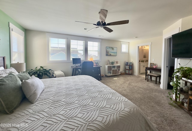 bedroom featuring ensuite bath, ceiling fan, and carpet